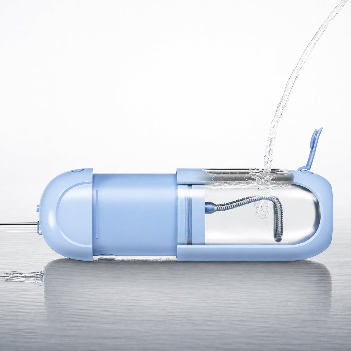 A light blue portable electric toothbrush shown on a reflective surface with water being poured into its charging port, against a clean white background.