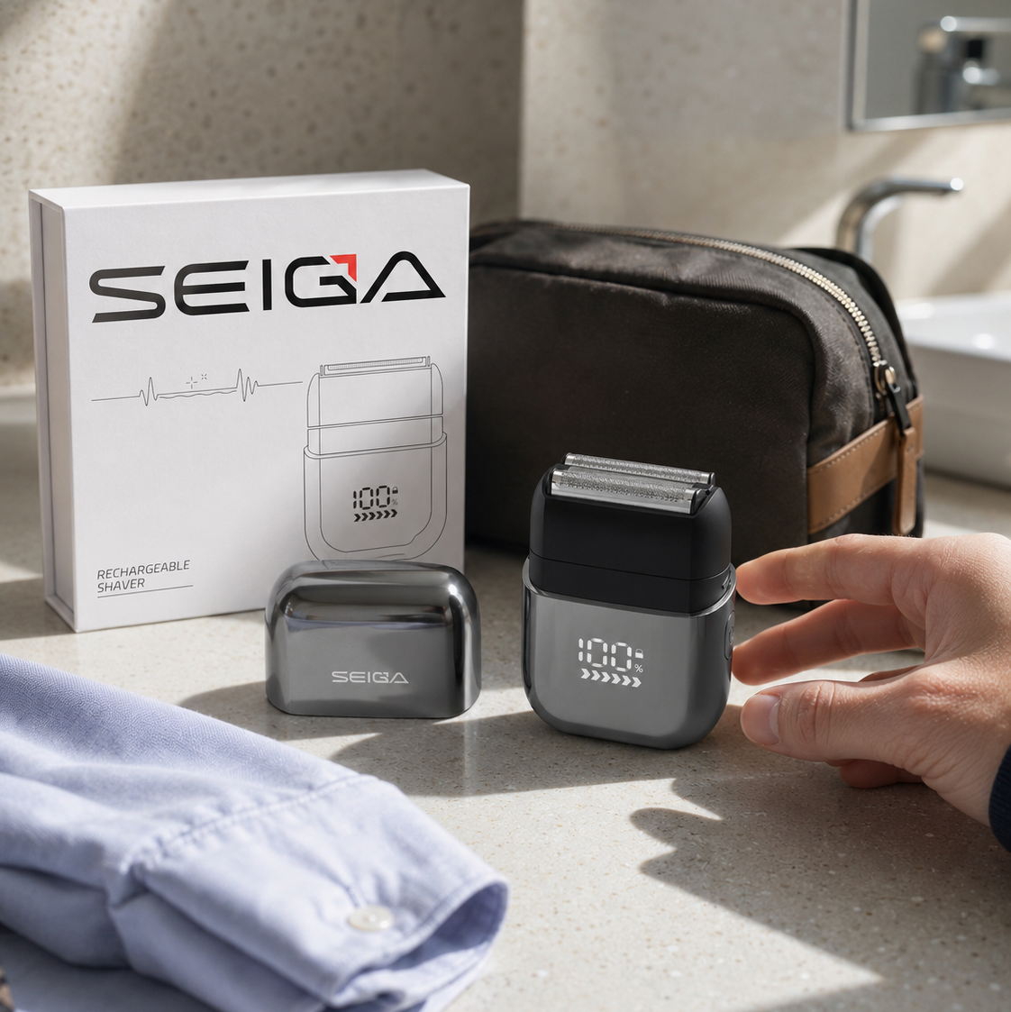 SEIGA rechargeable electric shaver and its charging case on a bathroom counter, with the product box, a dark travel pouch, a folded light blue shirt, and a watch nearby. A hand is touching the shaver.