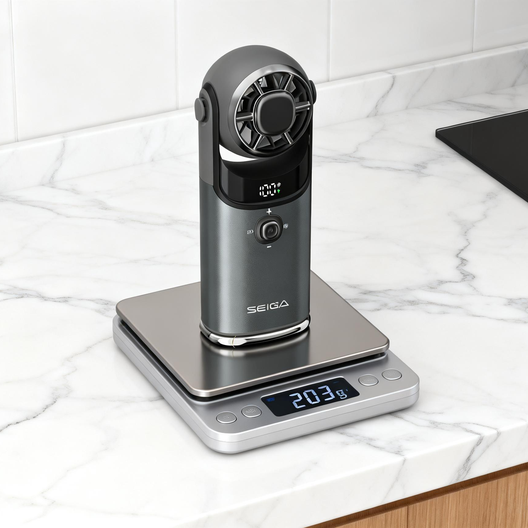 A digital kitchen scale with a sleek silver and dark gray body, shown displaying '203 g' on its screen while holding a dark gray food scale camera. The scale is set on a white marble kitchen countertop next to a black stovetop and a stainless steel pot.
